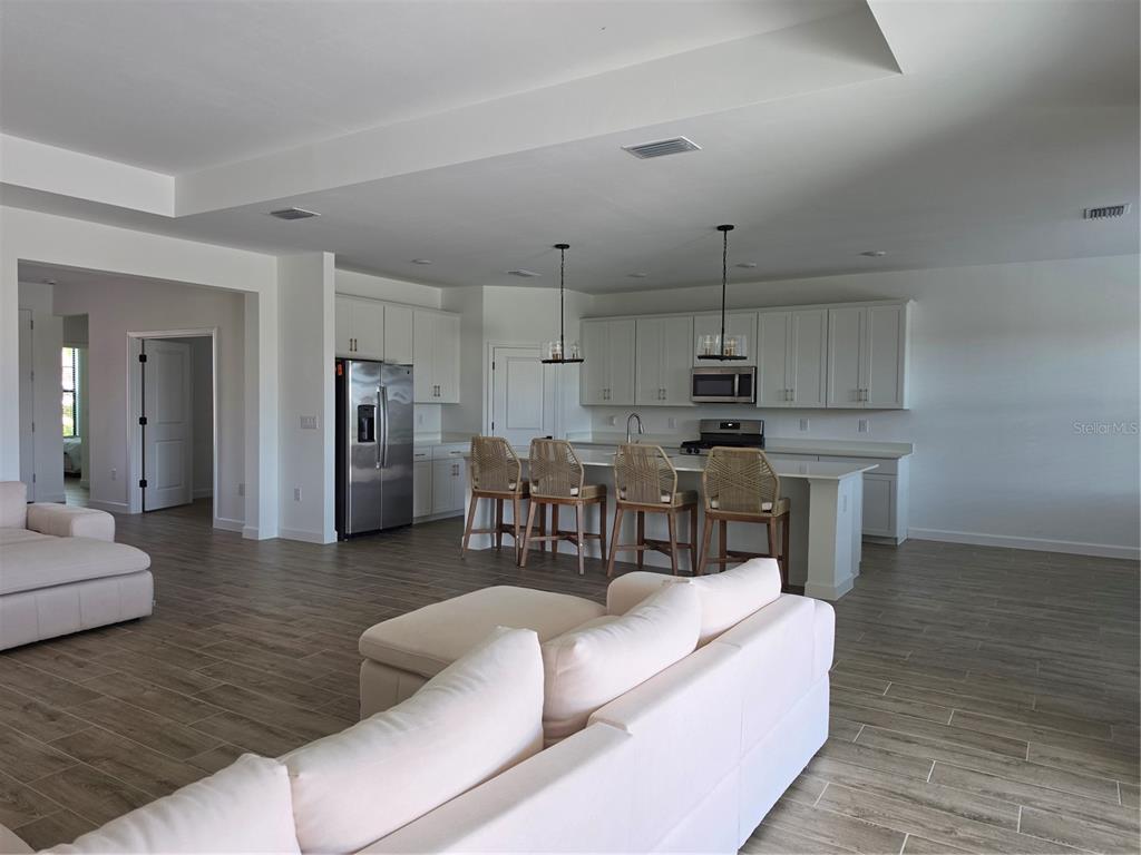 18334 Ridgeline Drive Estero, FL 33928 - Photo 6 of 30 a living room with furniture and kitchen view