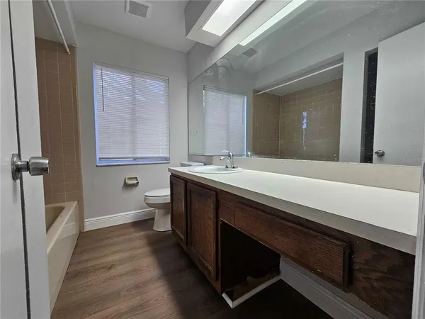 a bathroom with a sink a toilet and a mirror