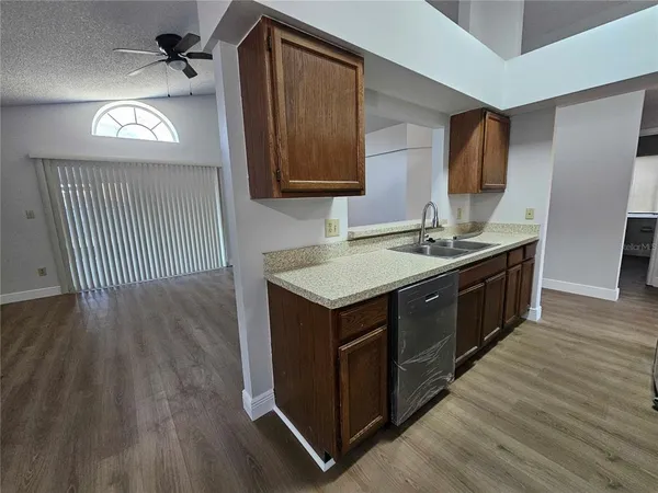 a kitchen with a sink cabinets and wooden floor