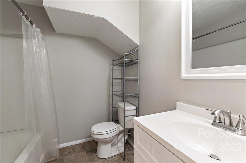 1235 Scaleybark Road, Unit E Charlotte, NC 28209 - Photo 14 of 23 a bathroom with a sink a toilet and shower