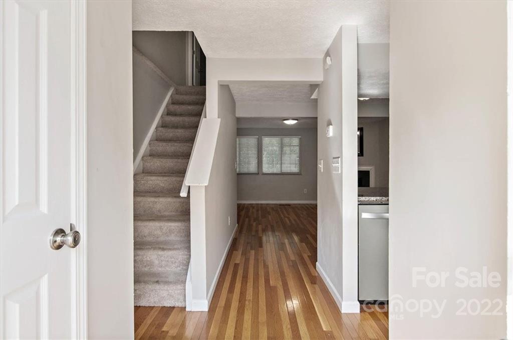 1235 Scaleybark Road, Unit E Charlotte, NC 28209 - Photo 4 of 23 a view of a hallway with wooden floor and staircase
