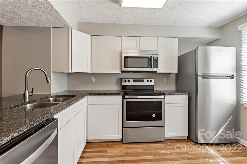 1235 Scaleybark Road, Unit E Charlotte, NC 28209 - Photo 6 of 23 a kitchen with a refrigerator sink and microwave