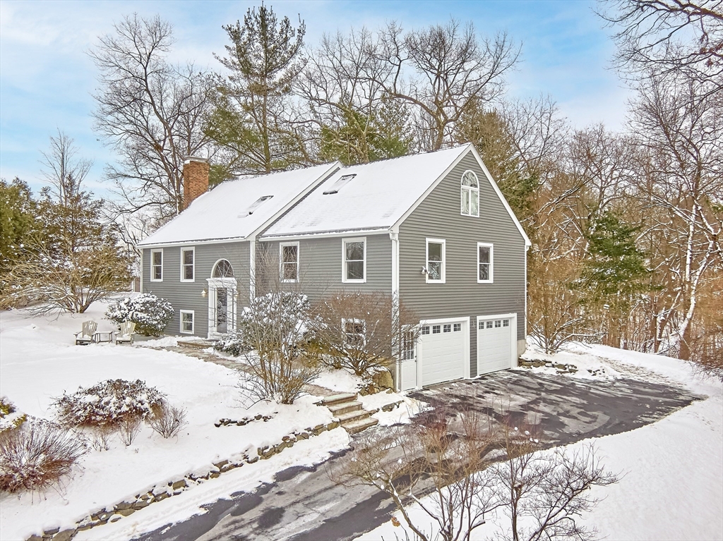 a front view of a house with a yard covered with snow in front of house