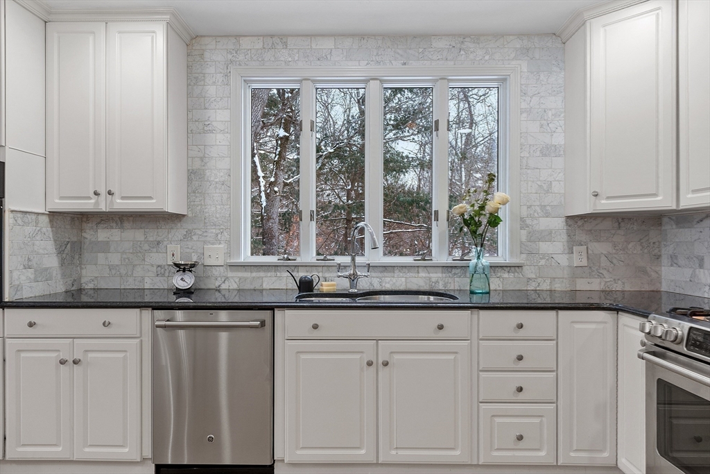 30 Duck Road Reading, MA 01867 - Photo 19 of 42 a kitchen with granite countertop white cabinets and a sink