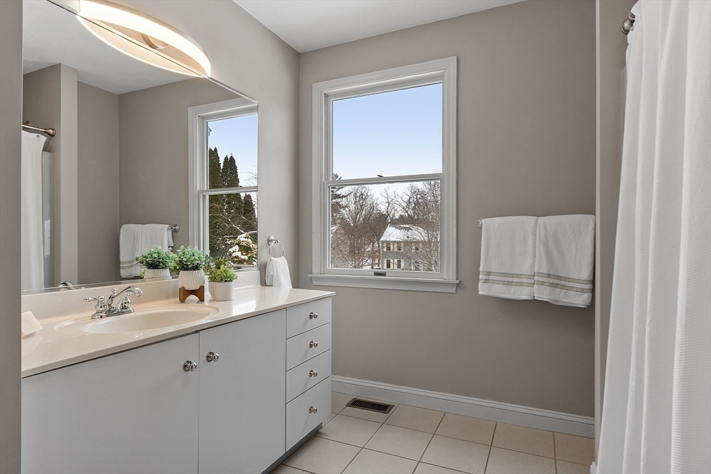 30 Duck Road Reading, MA 01867 - Photo 22 of 42 a bathroom with a sink double vanity granite and a mirror