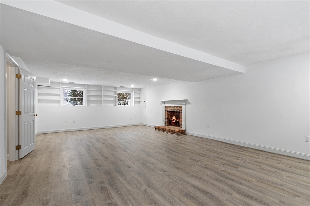 30 Duck Road Reading, MA 01867 - Photo 37 of 42 an empty room with wooden floor and windows