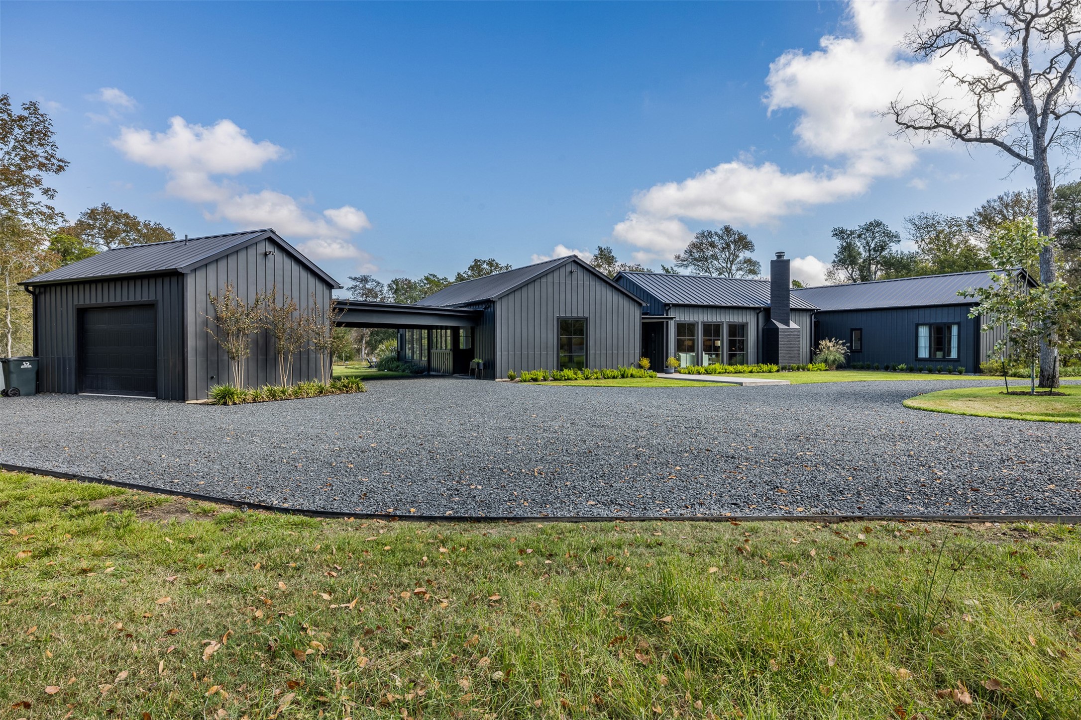830 South Weyand Road Round Top, TX 78954 - Photo 2 of 36 a front view of a house with garden