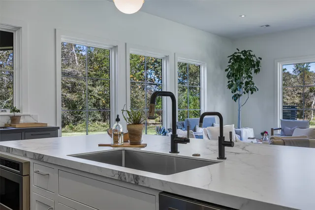 a kitchen with a sink and a large window
