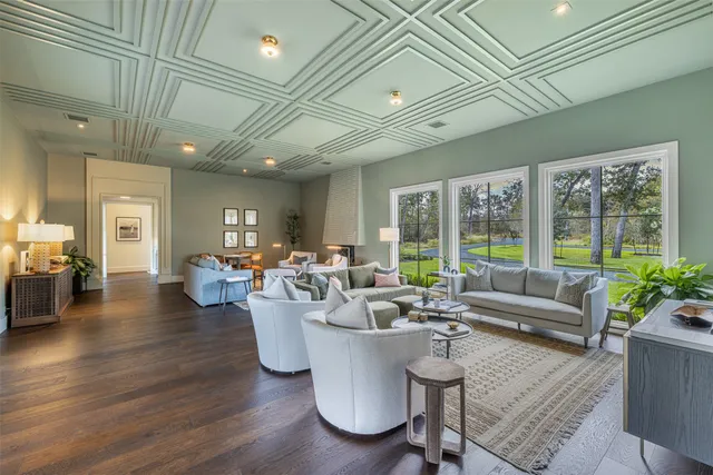 a living room with patio furniture and a large window