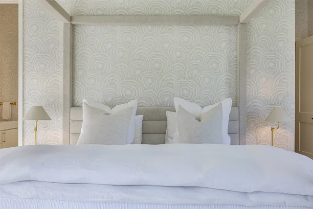 a bedroom with a bed and a lamp