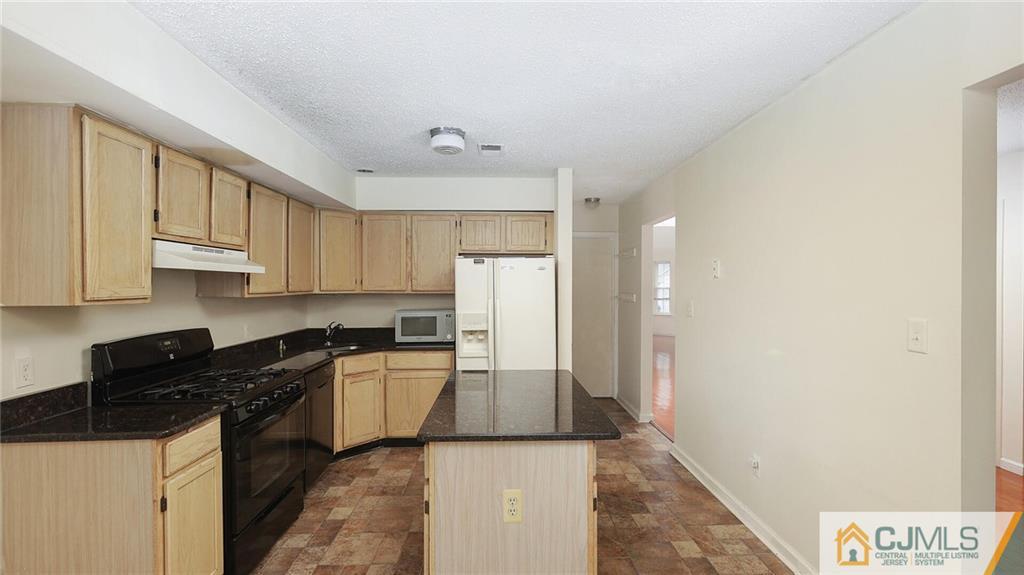169 Nebula Road Piscataway, NJ 08854 - Photo 19 of 31 a kitchen with stainless steel appliances granite countertop a refrigerator a stove and white cabinets