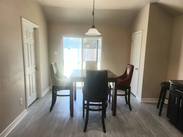a dining room with furniture window and wooden floor