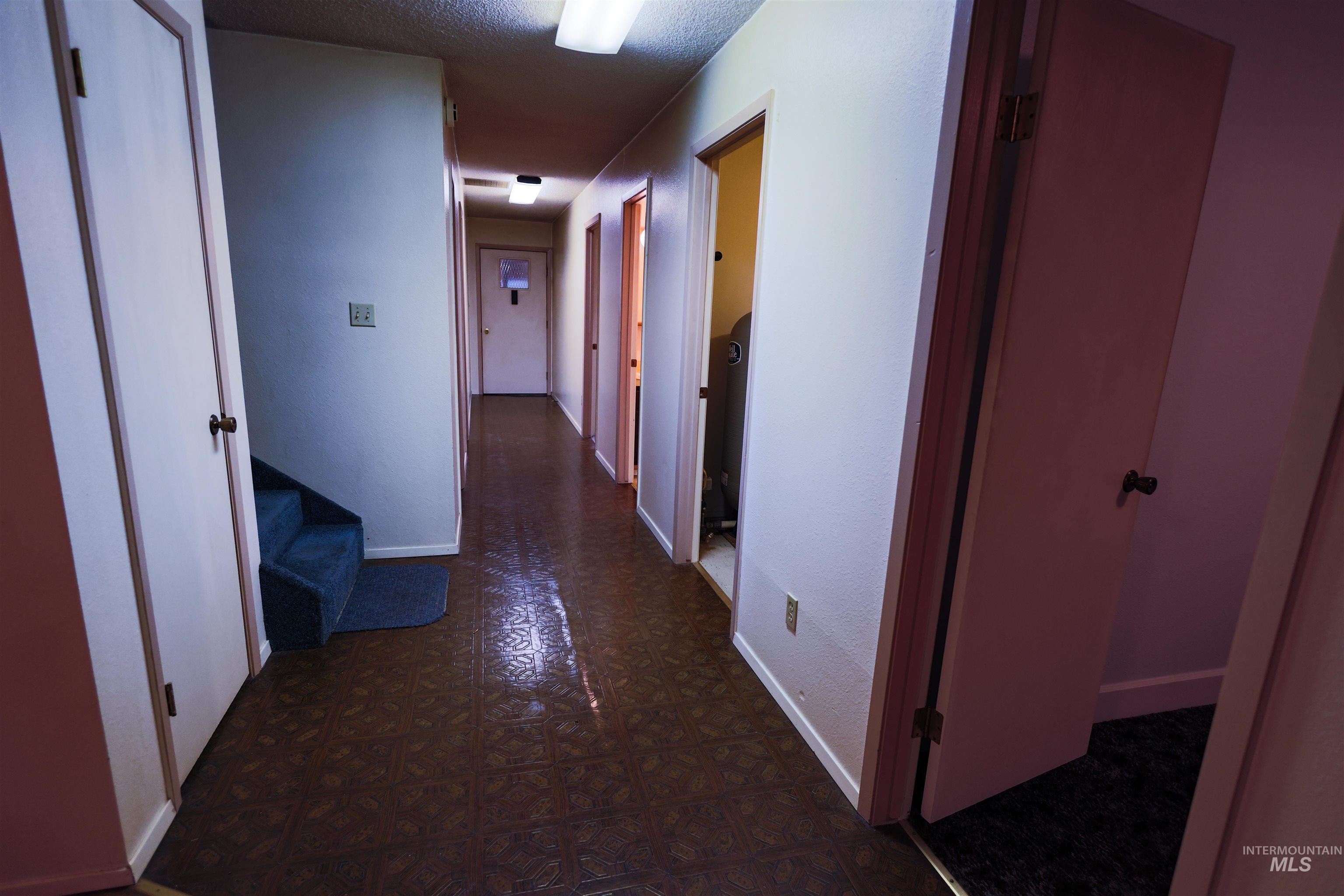 717 Big Cedar Road Kooskia, ID 83539 - Photo 17 of 50 Hall featuring a textured ceiling and dark floors