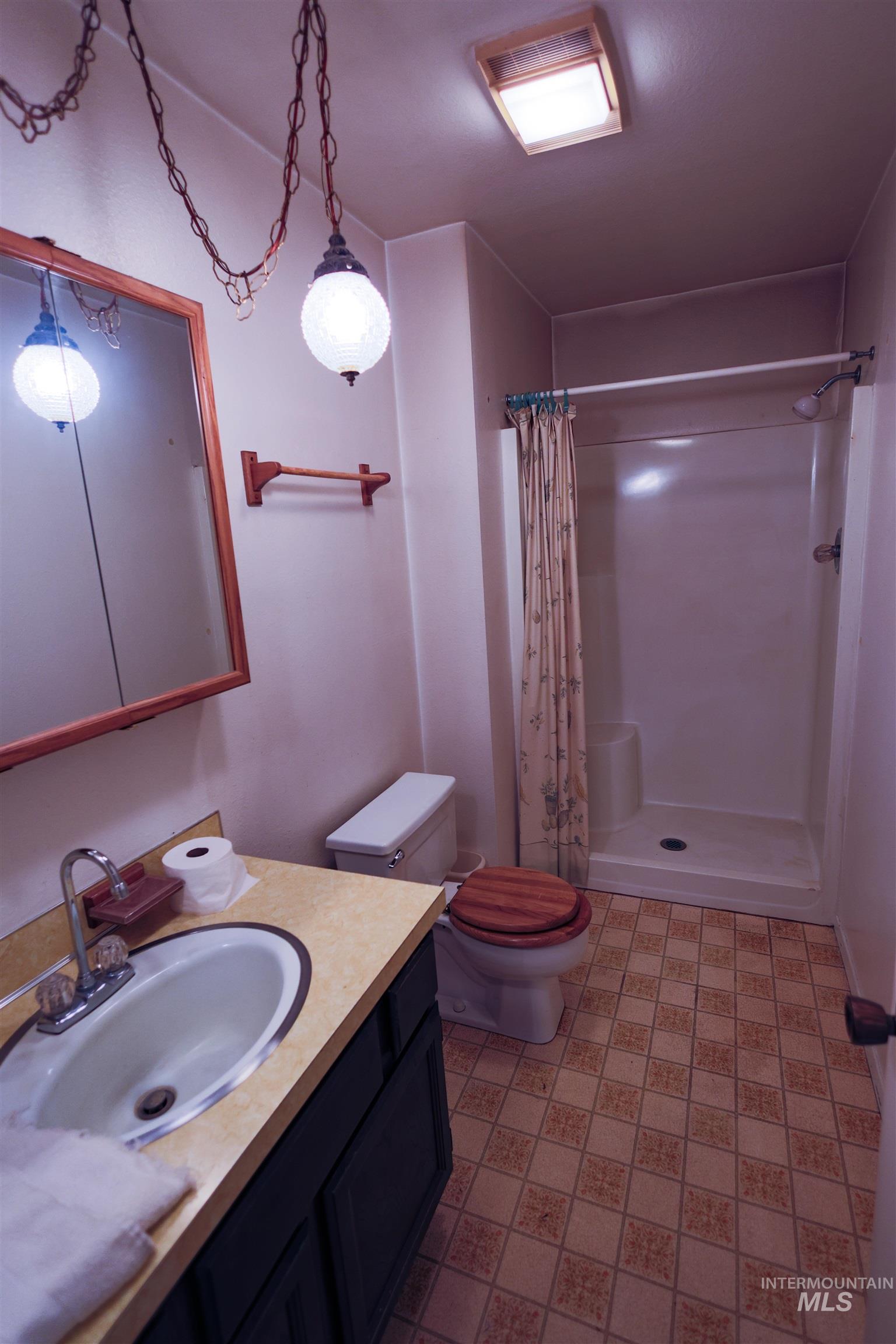 717 Big Cedar Road Kooskia, ID 83539 - Photo 20 of 50 Full bathroom featuring a shower stall, vanity, and light floors