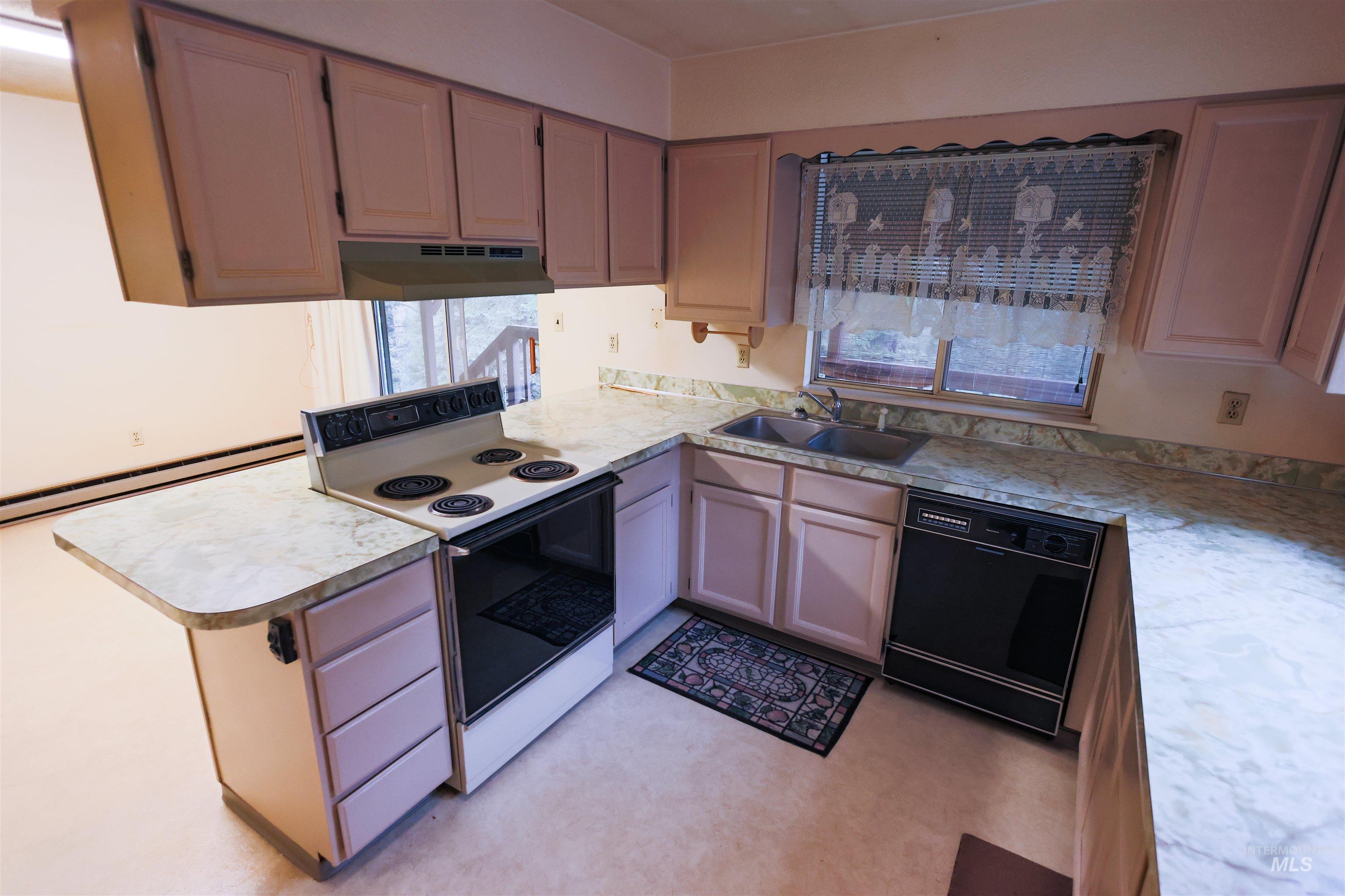 717 Big Cedar Road Kooskia, ID 83539 - Photo 4 of 50 Kitchen with electric range, light countertops, dishwasher, and a peninsula