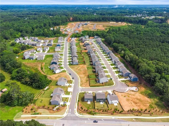 an aerial view of residential houses with outdoor space
