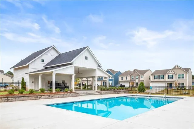 a view of houses with a outdoor space and swimming pool