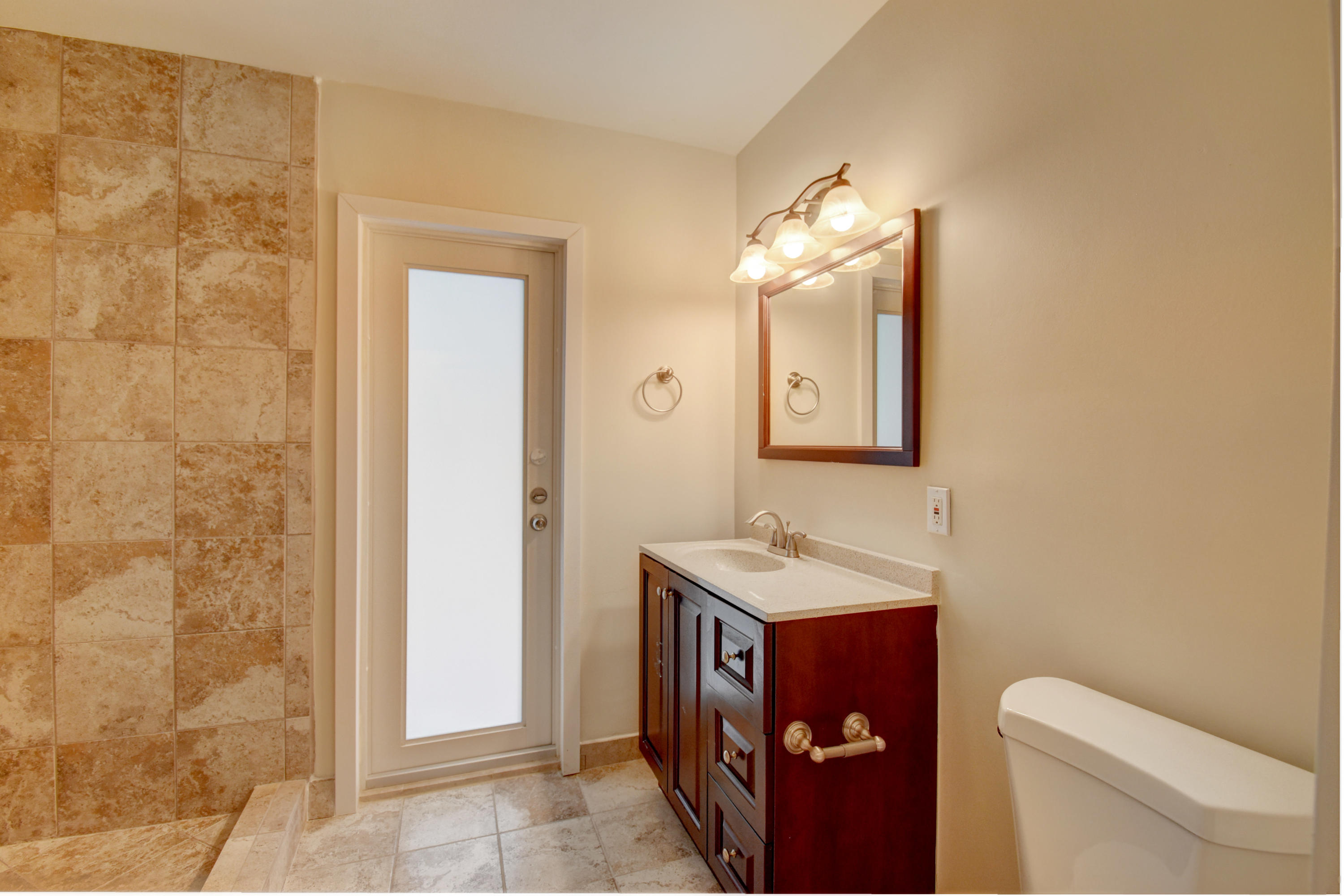 1266 Southwest 5th Street Boca Raton, FL 33486 - Photo 25 of 30 a bathroom with a toilet a sink and mirror