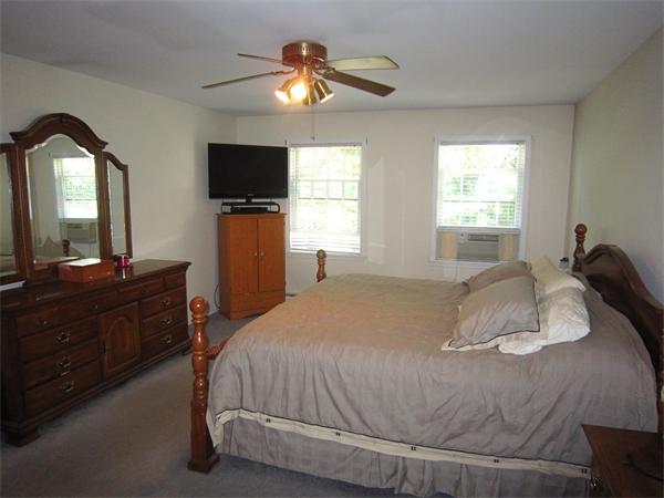 112 Sibley Road Waltham, MA 02453 - Photo 13 of 20 a bedroom with a bed and a flat screen tv