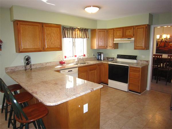 112 Sibley Road Waltham, MA 02453 - Photo 2 of 20 a kitchen with a stove a sink and a refrigerator