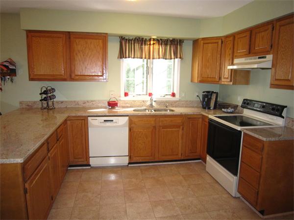 112 Sibley Road Waltham, MA 02453 - Photo 5 of 20 a kitchen with a sink stove top oven and cabinets