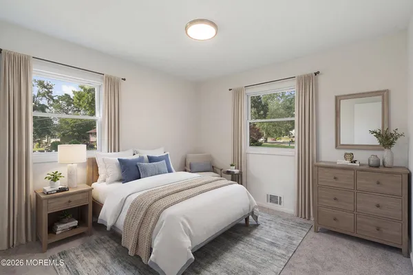 a bedroom with a bed and a dresser