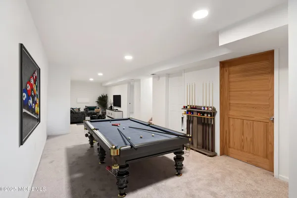a room with furniture pool table and flat screen tv