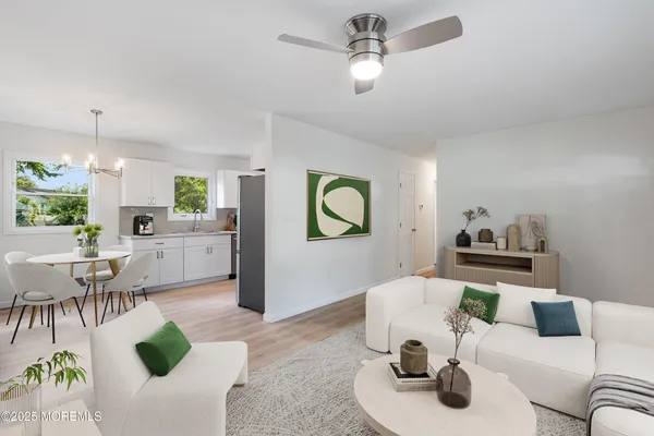 a living room with furniture and a chandelier