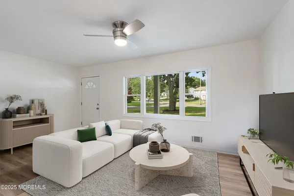 a living room with furniture and a flat screen tv
