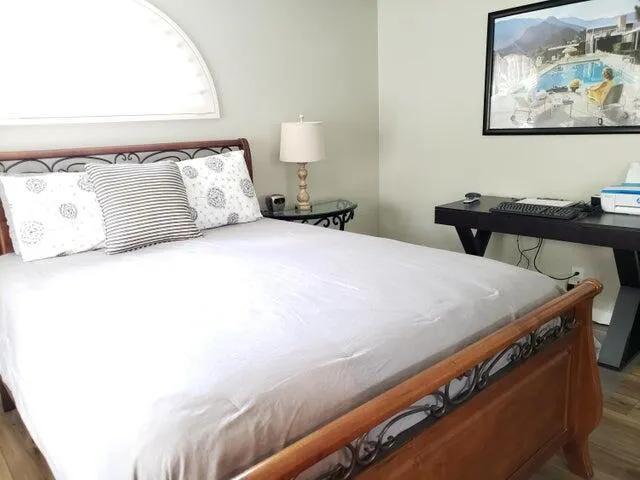 a bed sitting in a bedroom next to a window