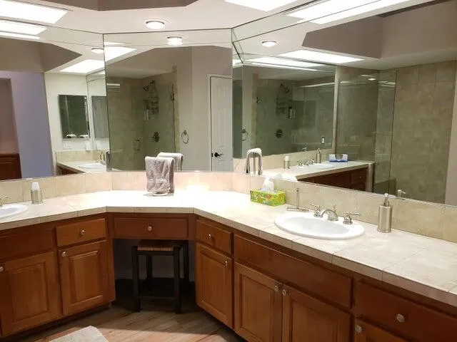 a bathroom with a sink double vanity and a mirror