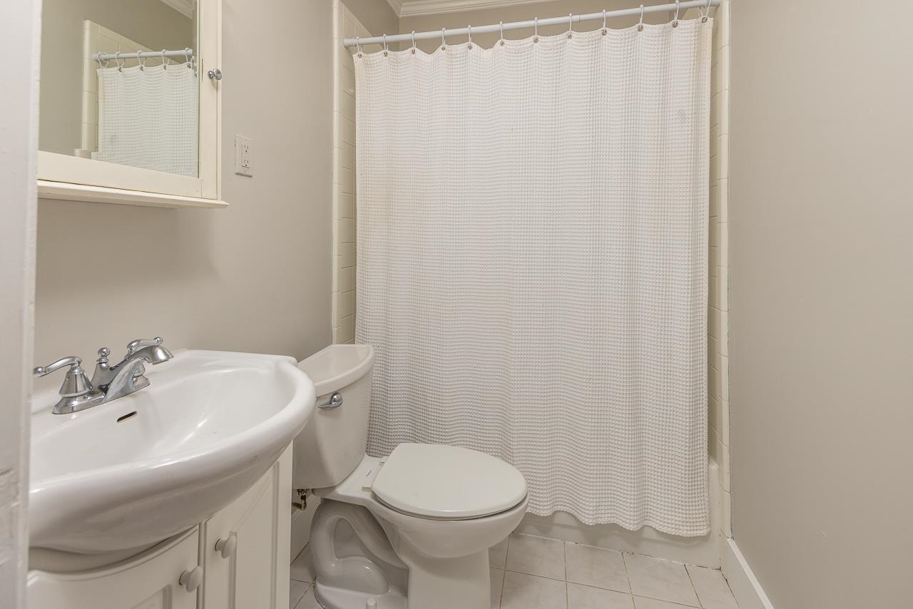 730 Shotwell Street Memphis, TN 38111 - Photo 13 of 20 a bathroom with a sink a toilet and shower curtain