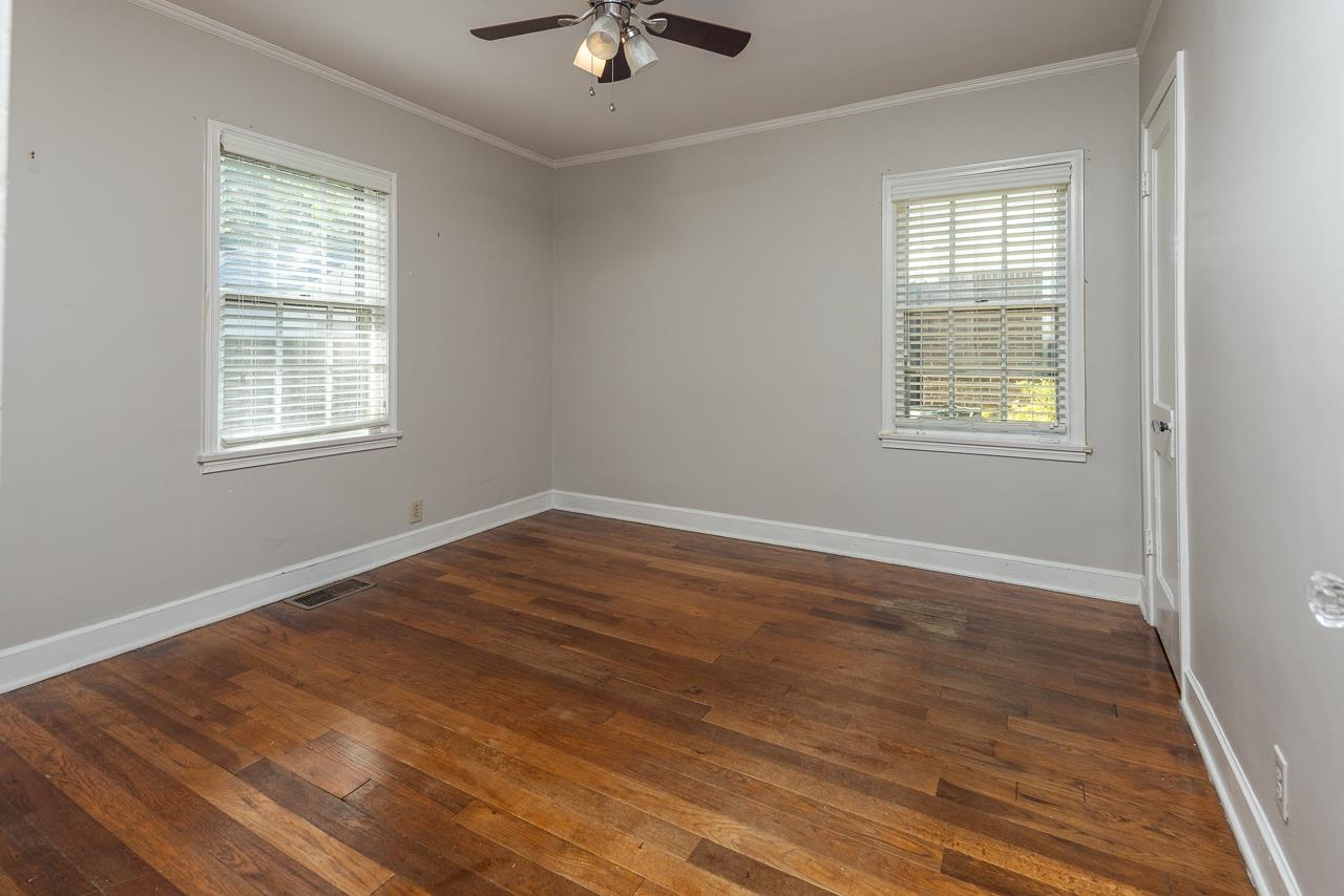 730 Shotwell Street Memphis, TN 38111 - Photo 16 of 20 a view of an empty room with wooden floor and a window