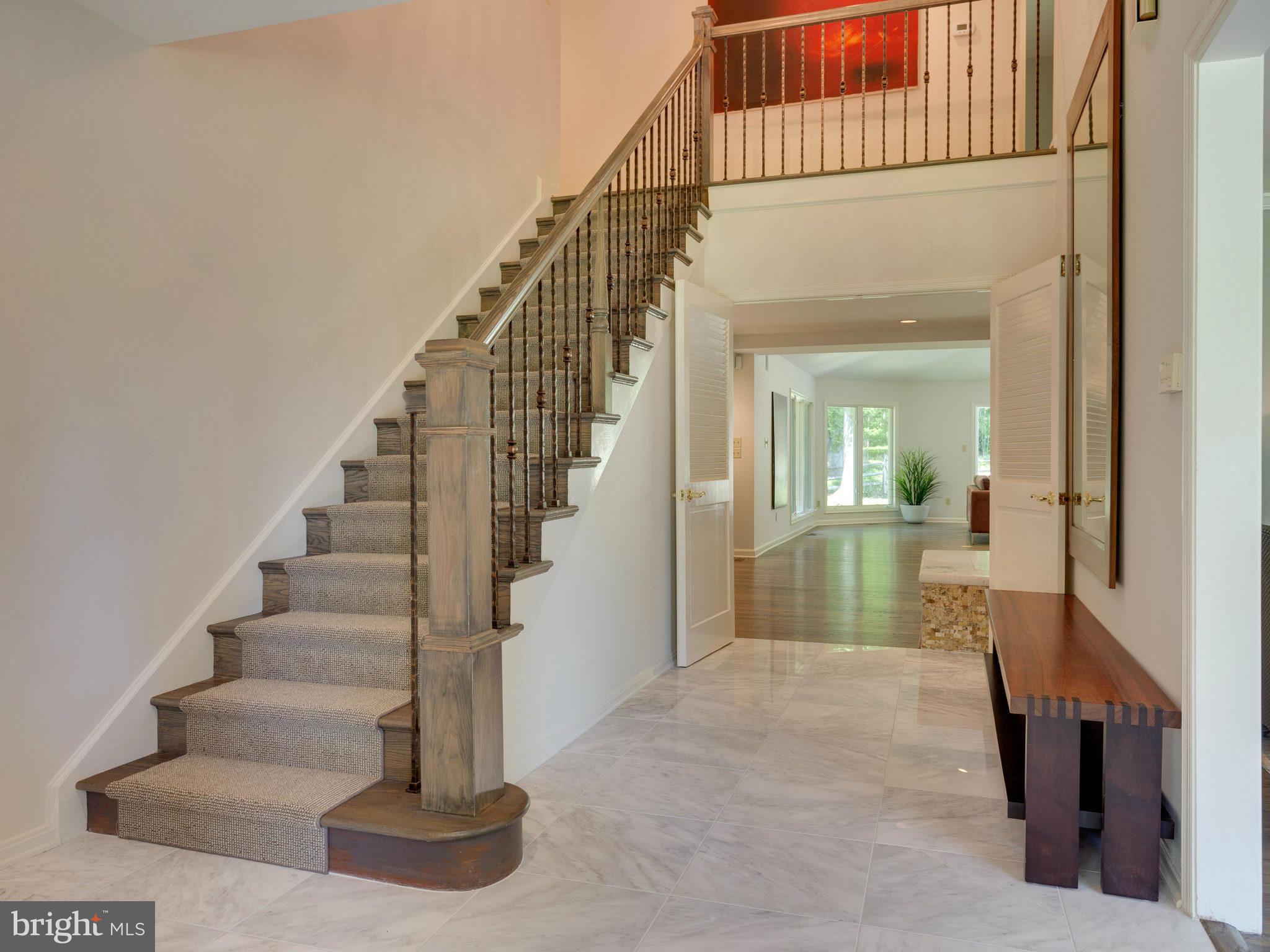 8416 Brook Road McLean, VA 22102 - Photo 2 of 30 Foyer-Carrara Marble Tile, Hammered Copper Railing