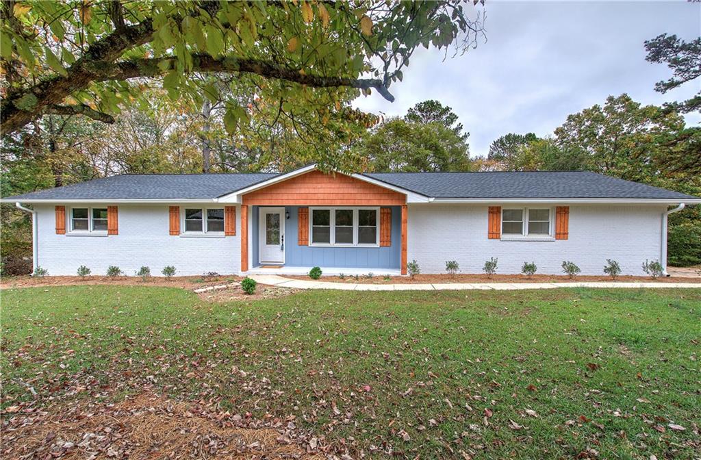 a front view of house with yard and trees