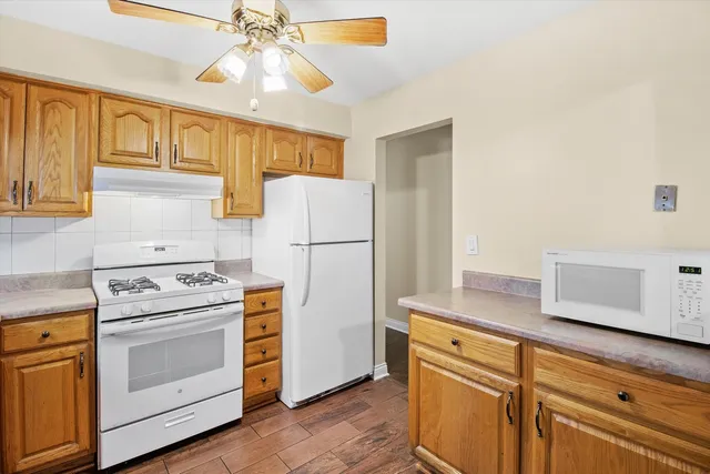a kitchen with a white cabinets and white appliances