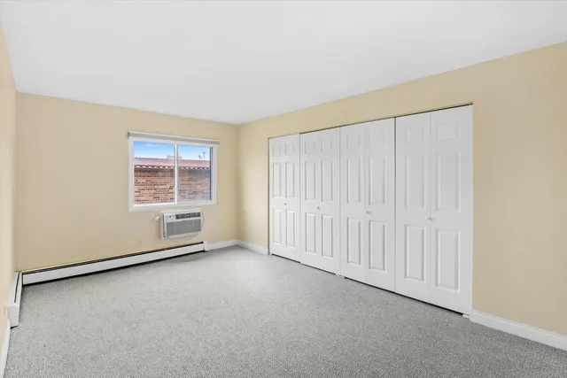 an empty room with a empty space and windows