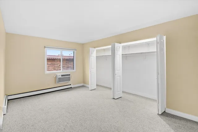 a kitchen with a refrigerator a stove top oven and cabinets