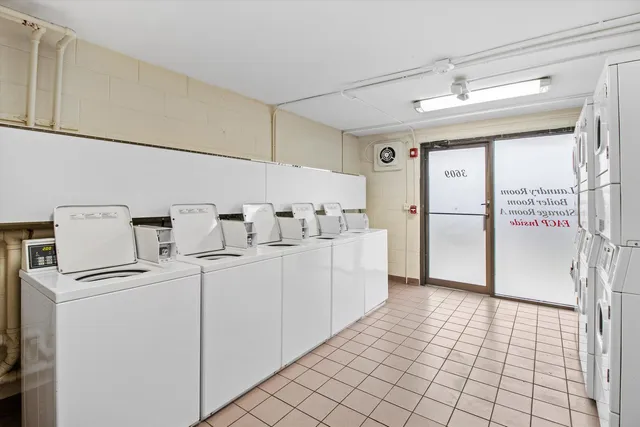 a white kitchen with a stove a sink and white cabinets