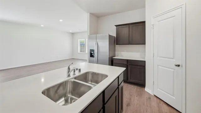 a kitchen with a sink and a refrigerator
