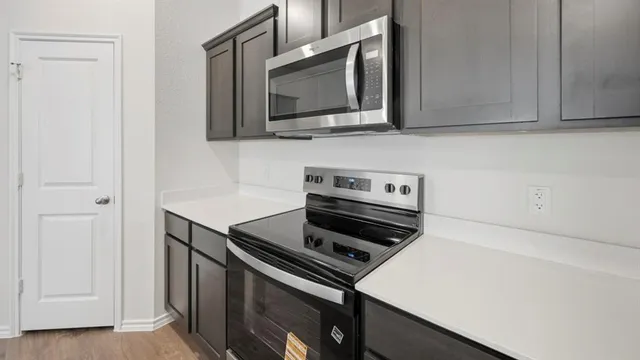 a kitchen with a stove and a microwave