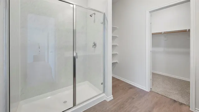 a bathroom with a glass shower door