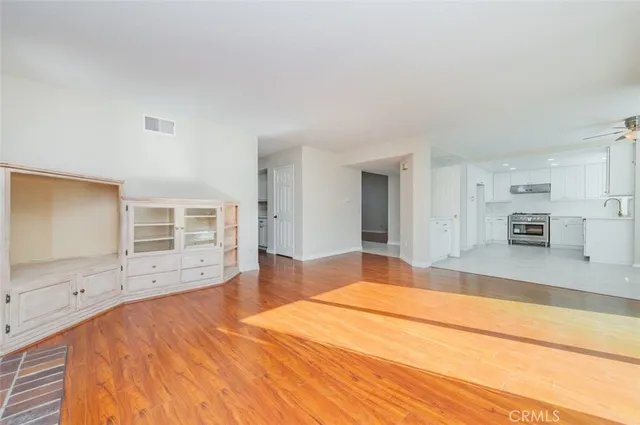 a large bedroom with a bed and wooden floor