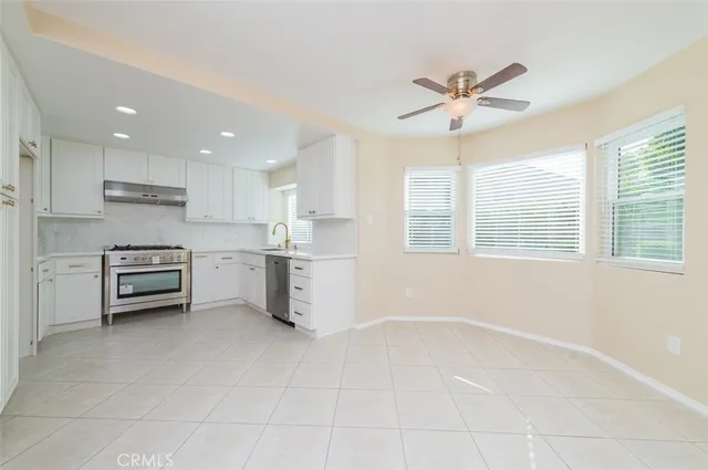 a kitchen with stainless steel appliances a stove a sink and cabinets
