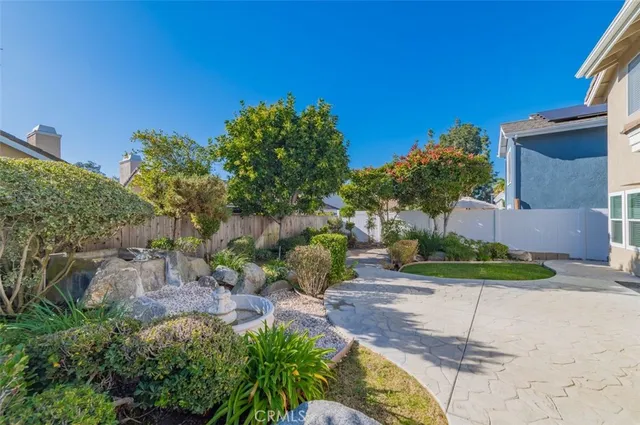 a view of a backyard with plants and a garden