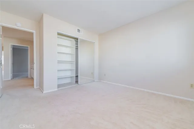 a view of an empty room and closet area