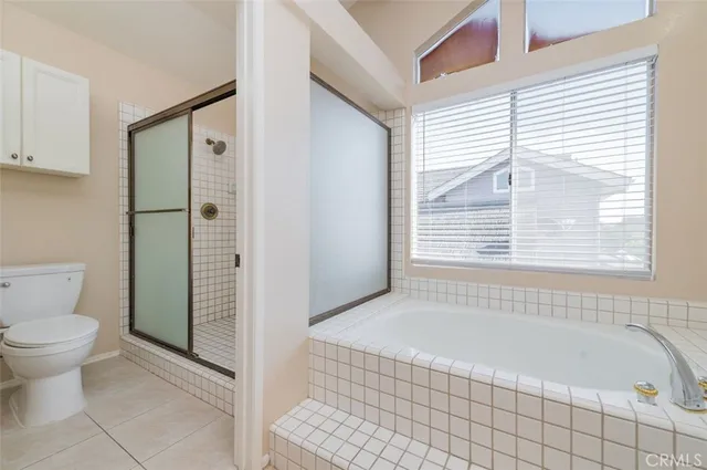 a bathroom with a granite countertop bathtub and a toilet