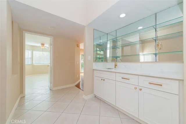 a spacious bathroom with a granite countertop sink a mirror and a shower