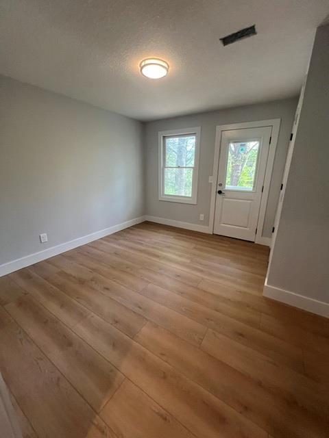 1616 Abe Cove Road Hiawassee, GA 30546 - Photo 14 of 17 an empty room with wooden floor and windows