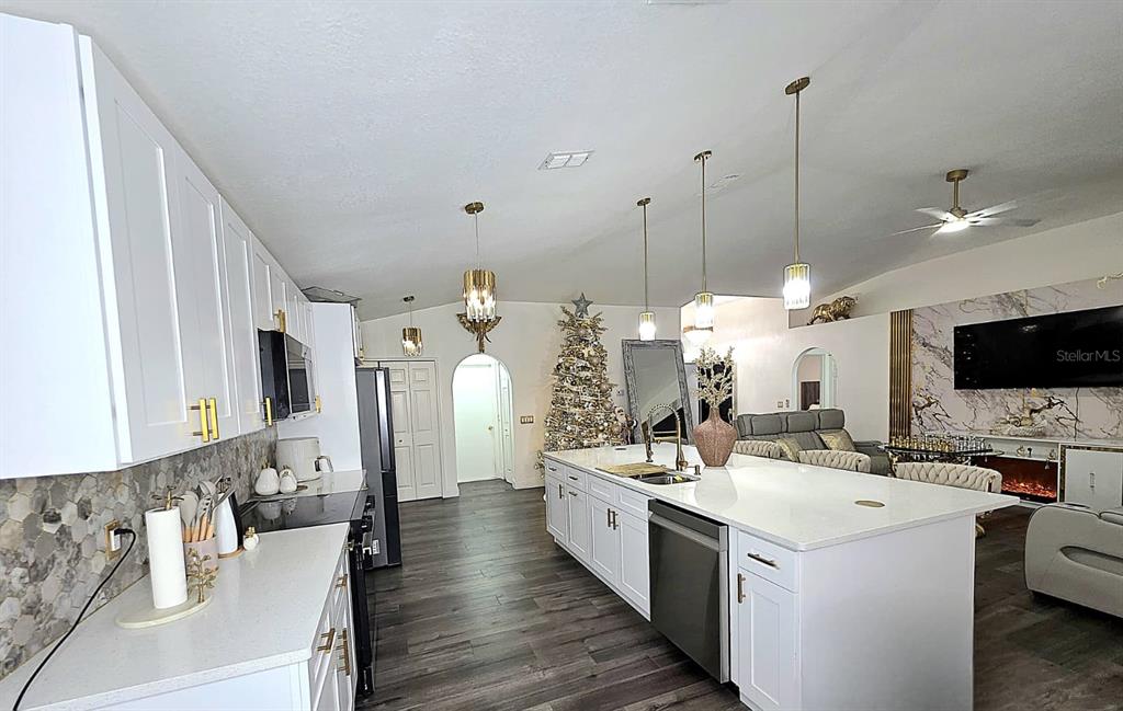 24921 Ravello Street Land O Lakes, FL 34639 - Photo 20 of 36 a large white kitchen with sink and refrigerator